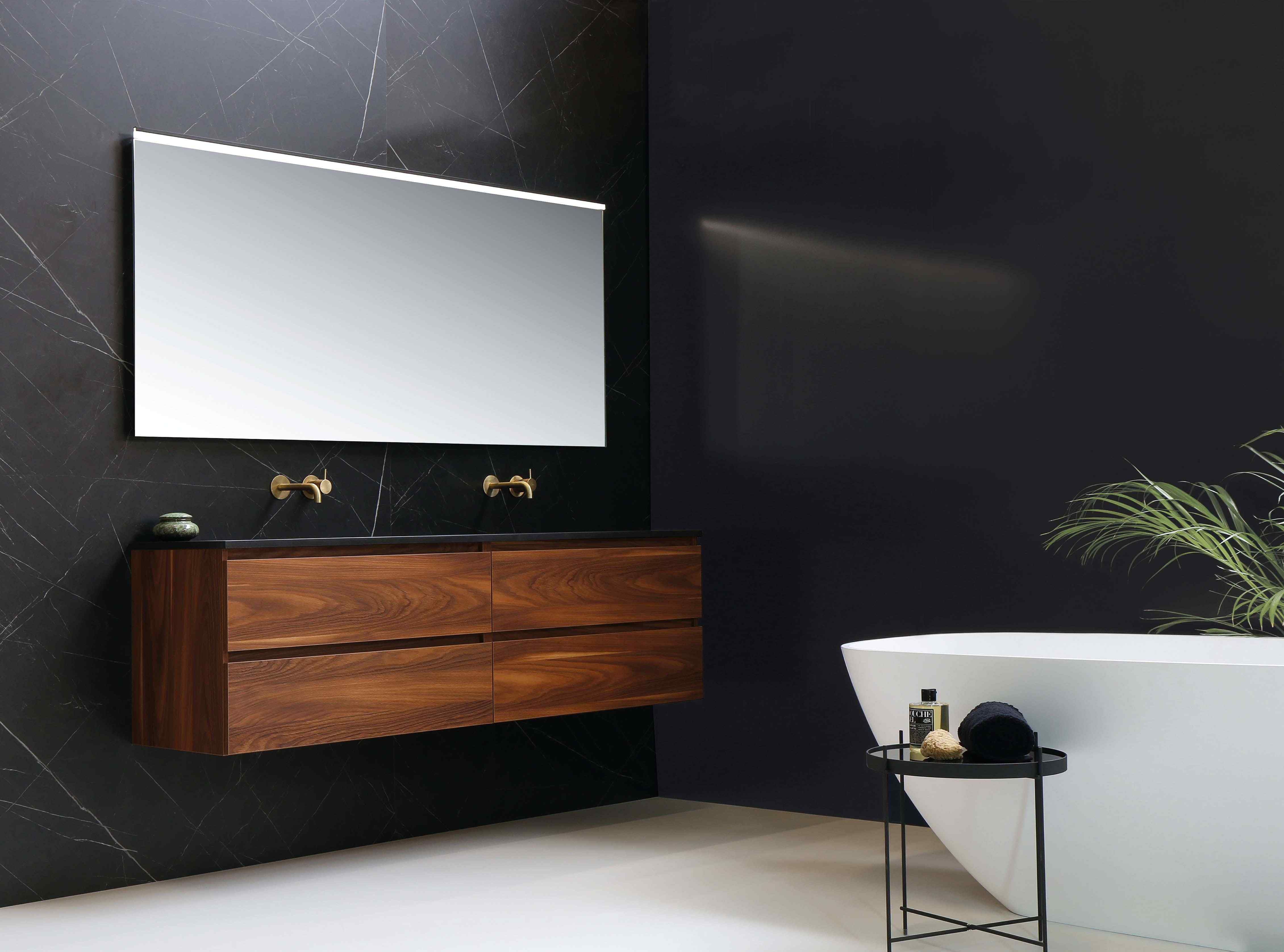 Elegant wood vanity in bathroom with white tub