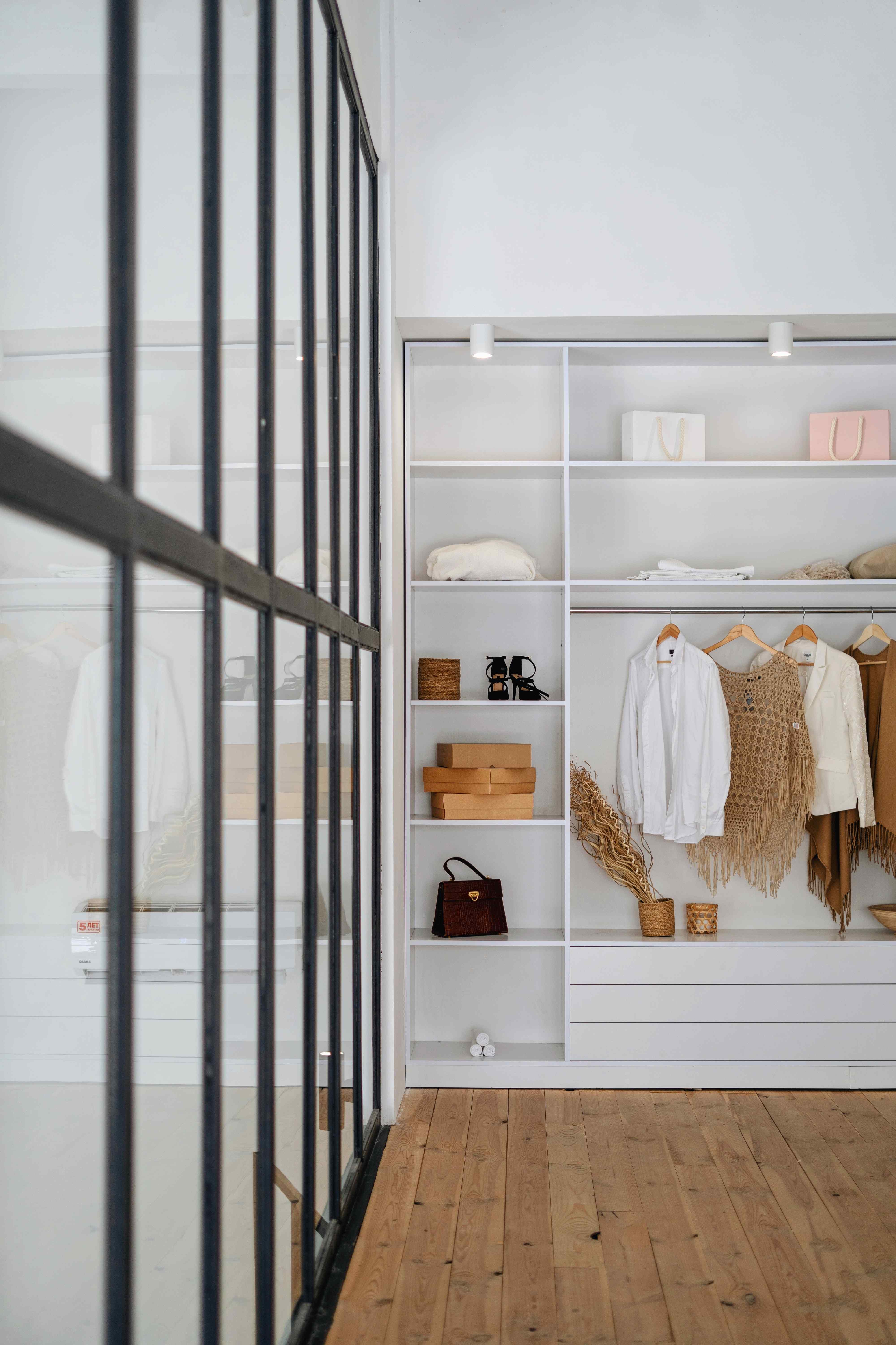 A neatly organized closet filled with a variety of clothes and shoes.