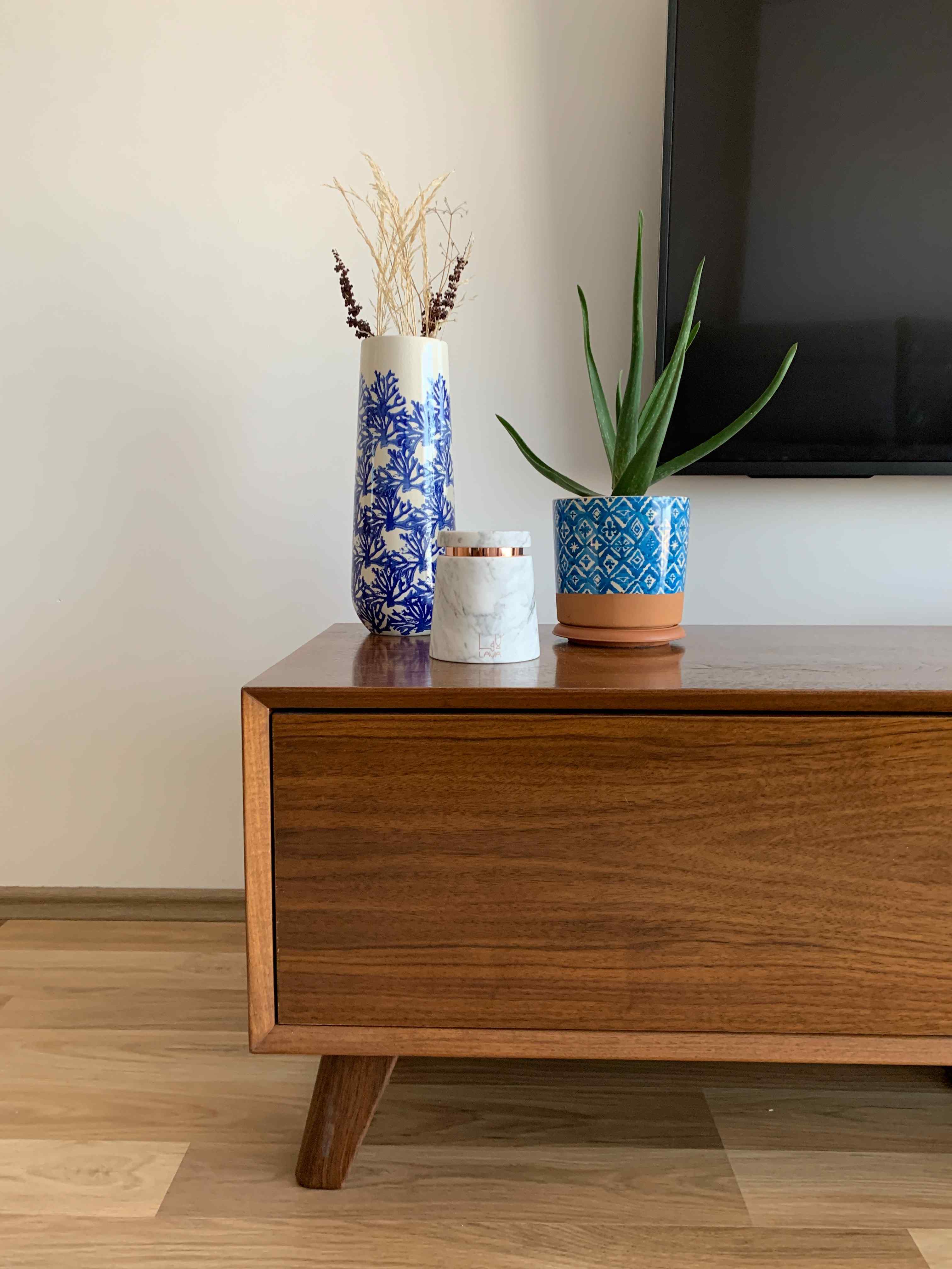 A wooden table adorned with a vibrant plant