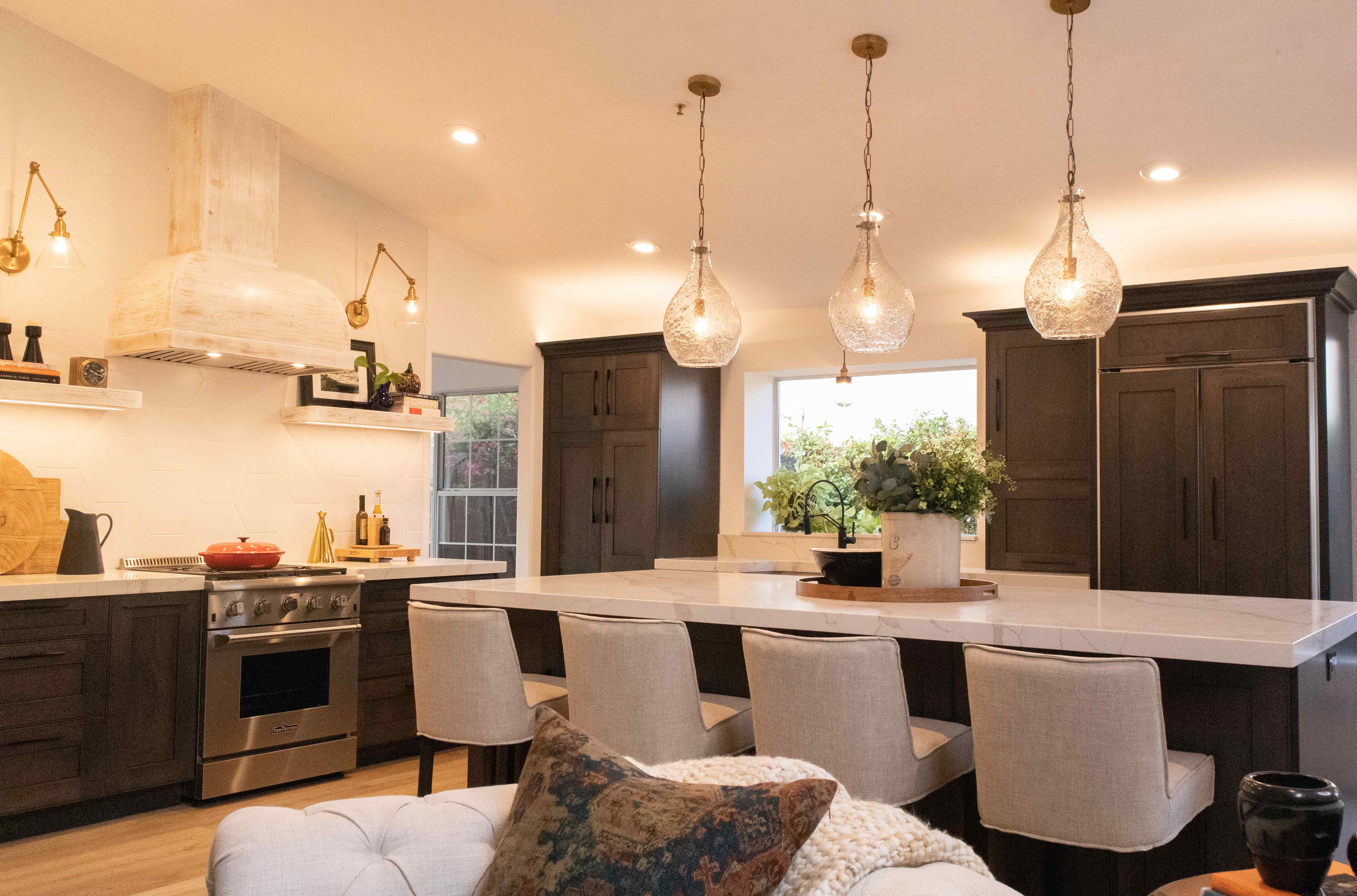 A well-designed kitchen with a central island and a stylish couch