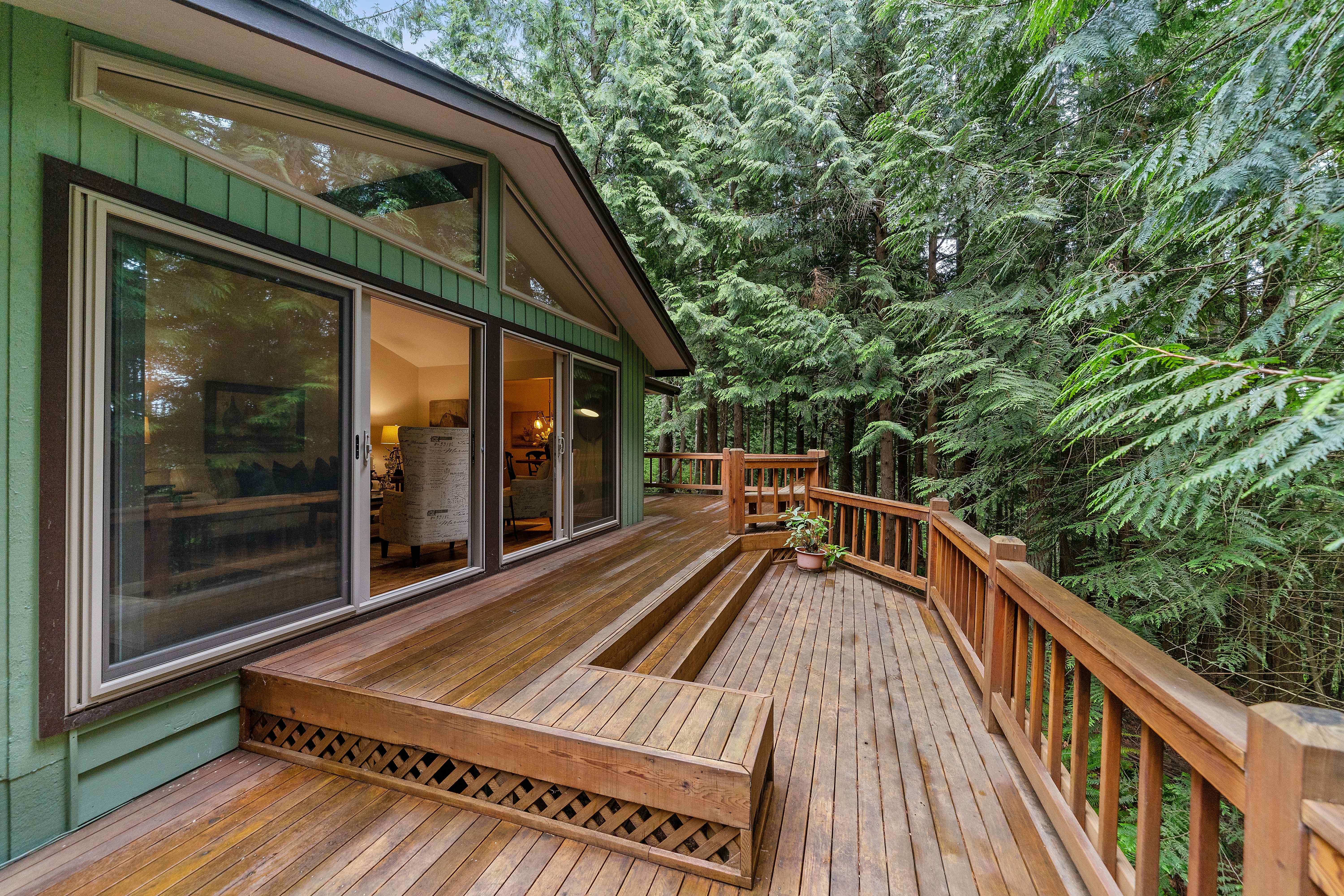 Wooden deck and railings in a lush green setting