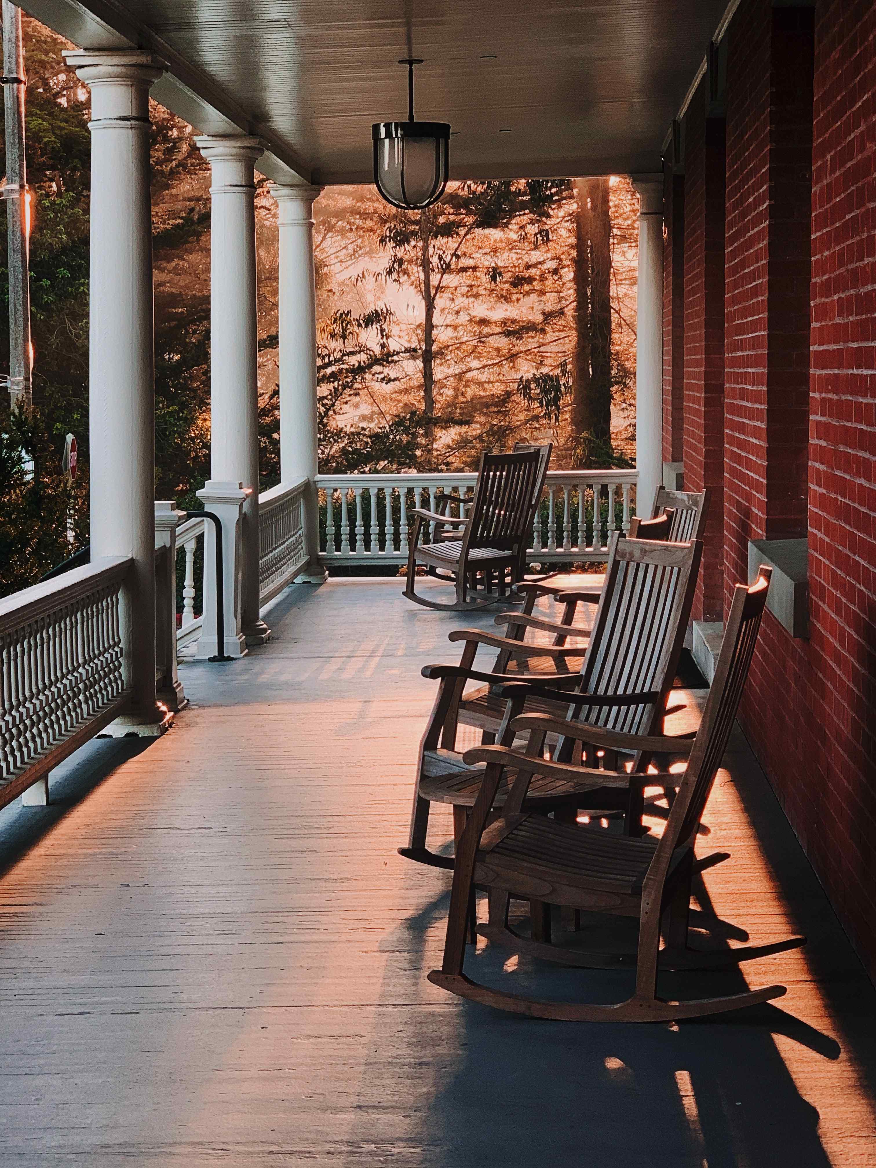 Cozy porch with rocking chairs and a warm porch light